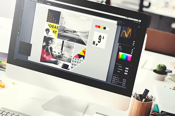 Website wireframes and UI layouts spread across a collaborative desk